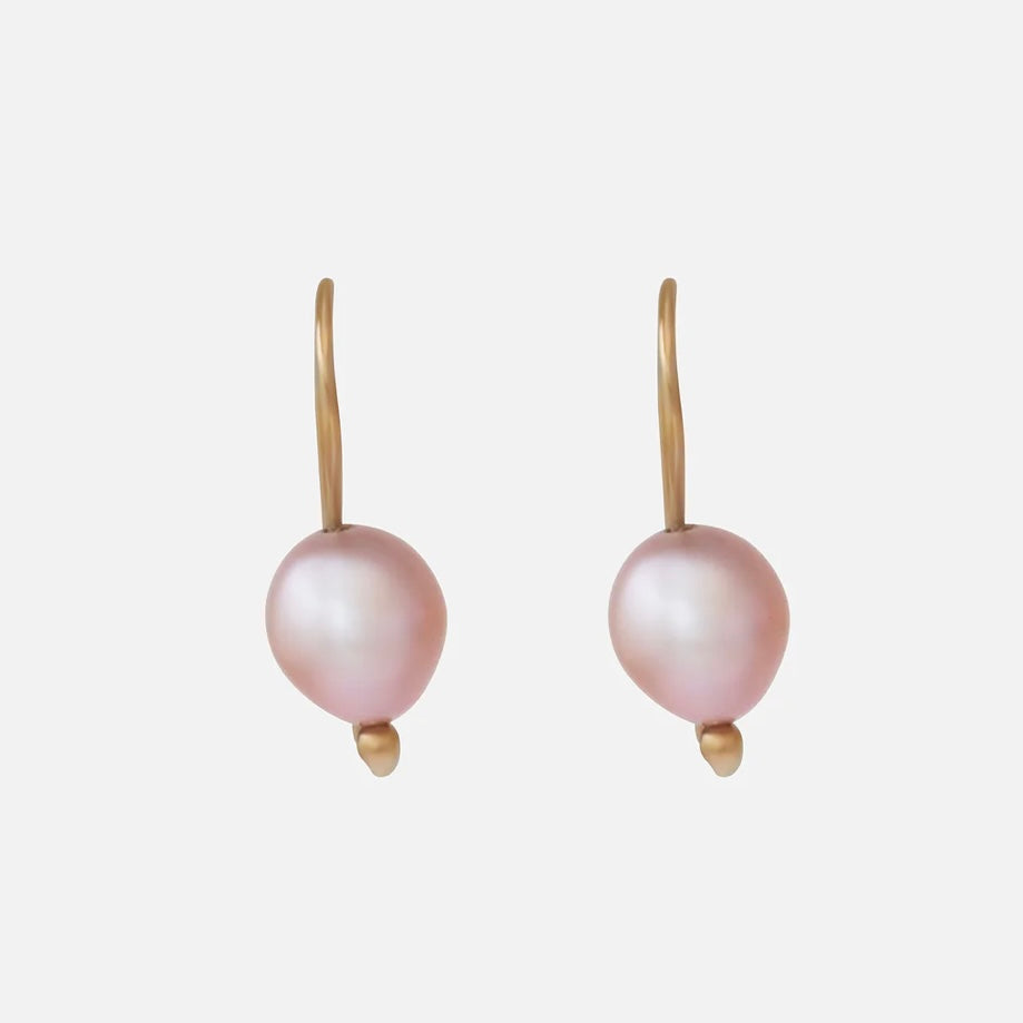The SWAN PEARL EARRINGS offer an elegant and timeless design crafted with high-quality materials. With their versatile style, these earrings are perfect for both formal occasions and everyday wear. Elevate your look with these stunning and sophisticated accessories.  Two 7.7mm pink fresh water pearls 14k yellow gold Satin finish Each earring measures 21.07mm width by 7.88mm length Sold as a pair