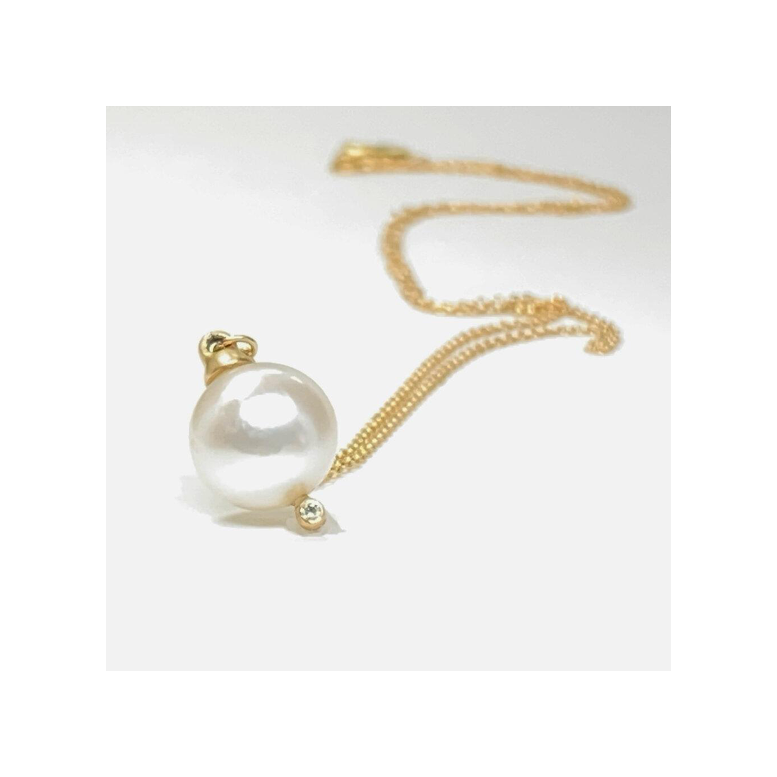 A classic single Japanese pearl necklace with a diamond to give it that extra sparkle.  Details  8mm Japanese Pearl 1 Round White Diamond 0.05ct Pendant measures 16.5mm x 9.75mm 18" Chain 14k Yellow Gold Satin Finish