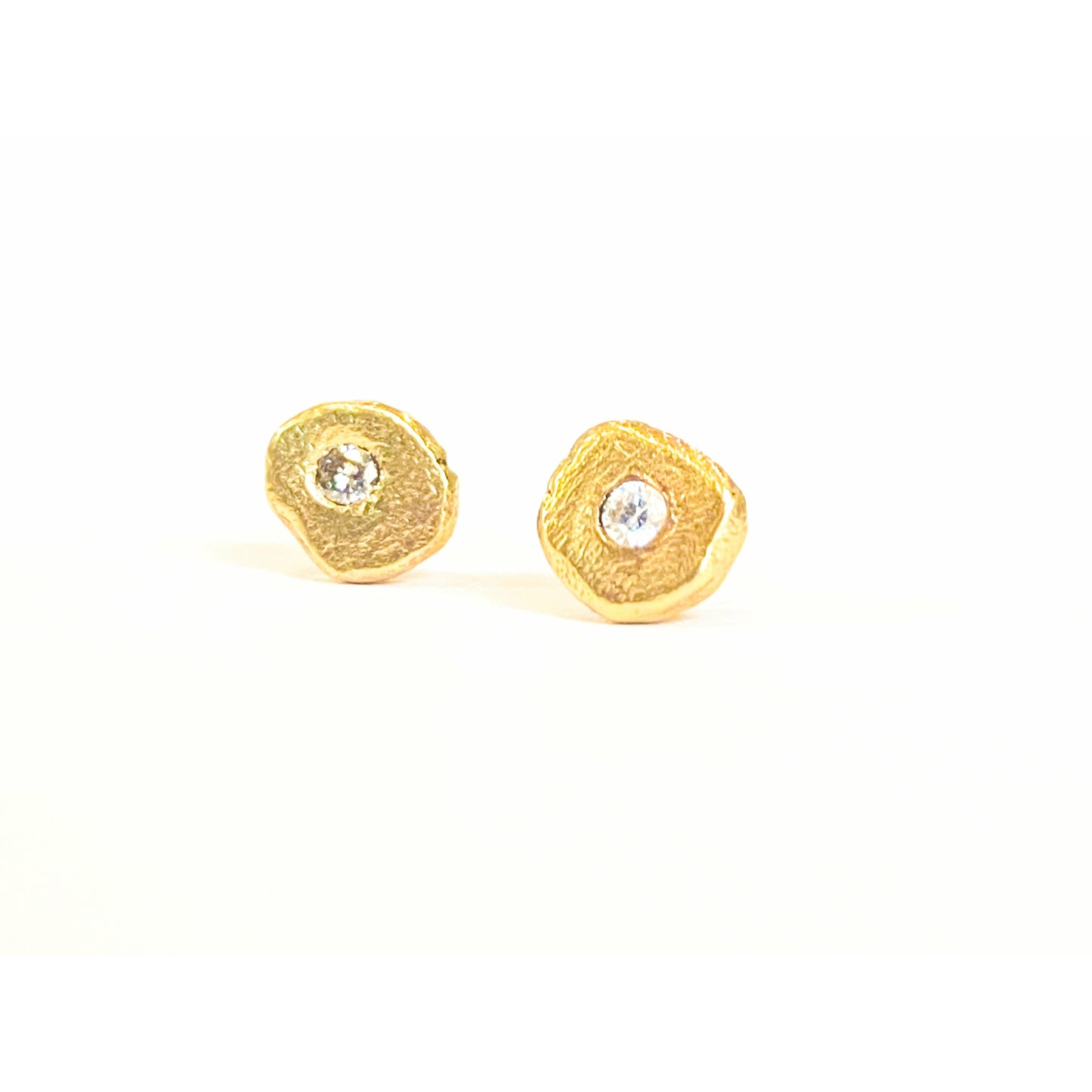Add a touch of elegance and sophistication to your look with these stunning textured diamond stud earrings. The intricate textured design adds a unique twist to the classic diamond studs, creating a sparkling and glamorous accessory that will elevate any outfit.  1.8 mm pointer diamond flush set.  6mm-6.25  not a regular shape textured.  small butterfly back.