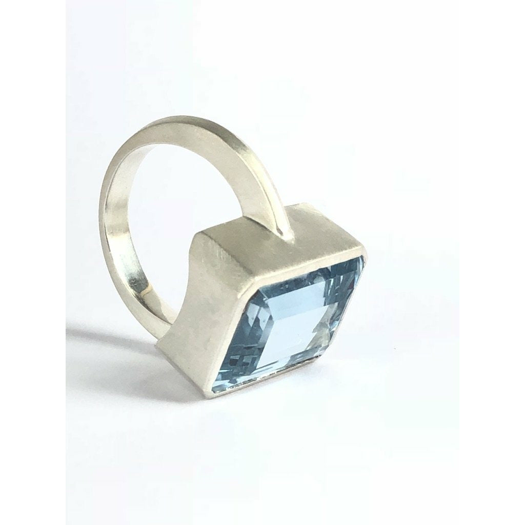 Add a touch of elegance to any outfit with this stunning Bright Blue Topaz Cocktail Ring. The vibrant blue color of the topaz stone is sure to catch everyone's eye, and the elegant cocktail design adds a sophisticated touch. Treat yourself or someone special to this eye-catching ring today!  16mm x 12mm Blue Topaz.
