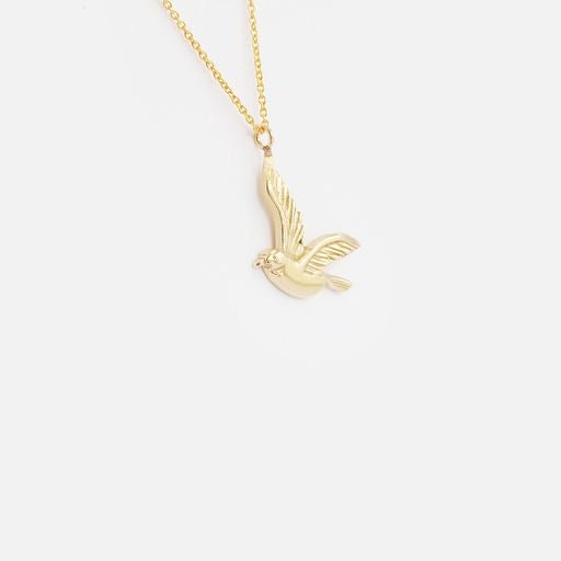 Introducing our elegant BIRD PENDANT, featuring a stunning design that captures the grace and beauty of birds in flight. Details  Carved Gold Bird  16" Chain  14k Yellow Gold  Pendant measures 18.3mm x 13.5mm