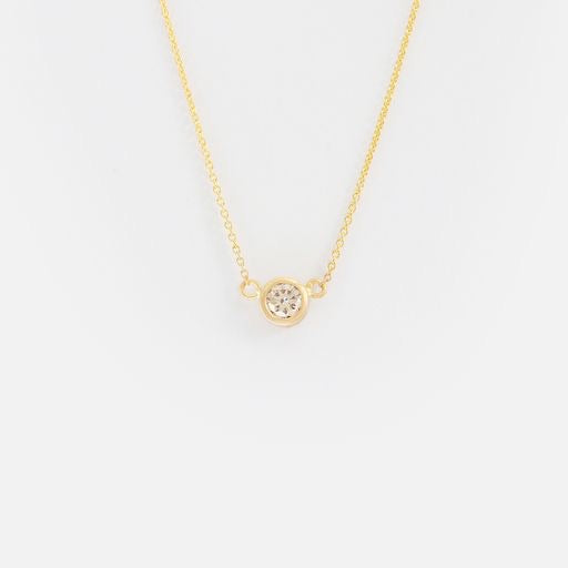  Details.  Indulge in the timeless elegance of our Single Diamond Pendant. Crafted with a sparkling diamond and a sleek design, this pendant is the perfect accessory to elevate any outfit. Add a touch of sophistication and brilliance to your look with our exquisite Single Diamond Pendant today.                 14k Gold                1  x 3.5mm Round White Diamond               16-Inch Round Chain 