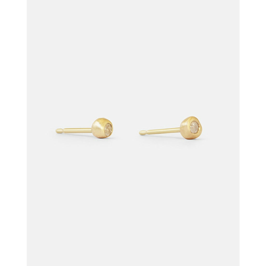 Add a touch of elegance to your everyday look with these stunning Dainty Ball Diamond Stud Earrings. Classic ball studs, with a Diamond they are  comfortable and Essential. Great for 2nd and 3rd ear piercings and cartilage earrings.   Details  2 x 1.5mm diamond 14k Yellow Gold W x T 3.5mm x 3.5mm