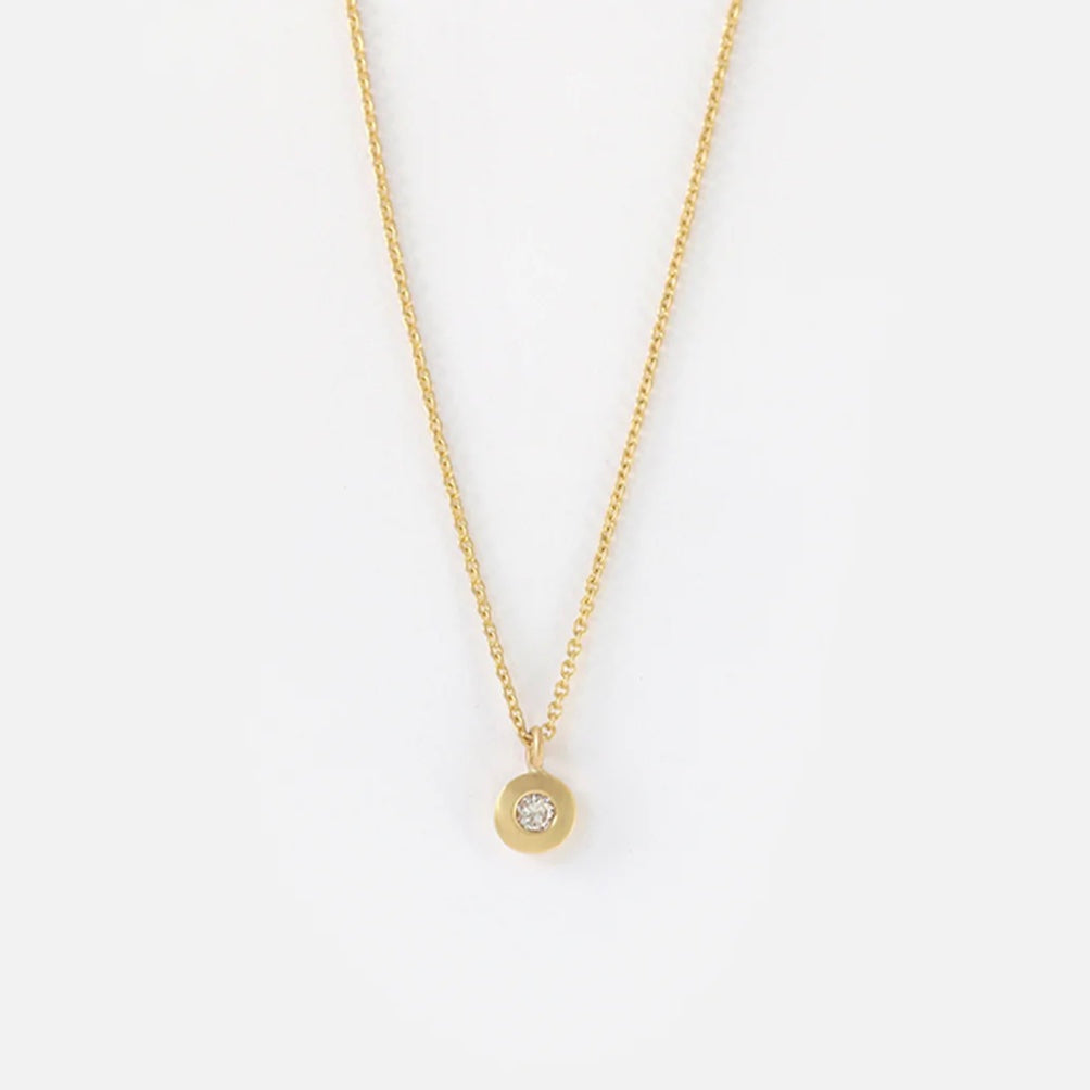 Introducing our exquisite Diamond Dot Necklace, a dazzling piece crafted with sparkling diamonds and a versatile design. This elegant necklace is the perfect accessory to elevate any outfit, adding a touch of sophistication and luxury  1mm round white diamond 16" Chain 14k Yellow Gold Satin Finish HxW: 4mm x 4mm