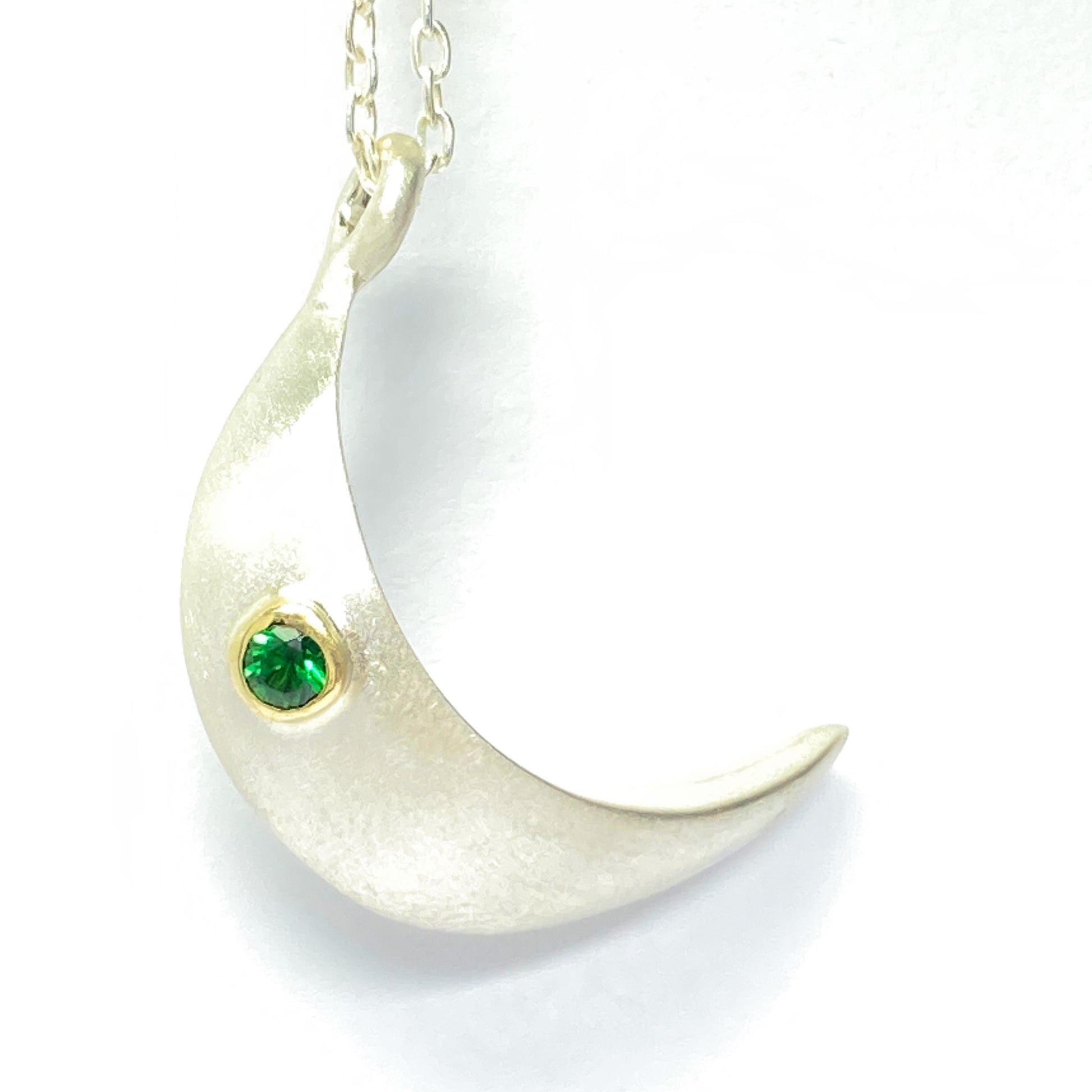 Keep your loved ones close to your heart with our cremation moon necklace. Crafted with care, this necklace allows you to carry a small portion of their ashes, providing comfort and a constant reminder of their presence.  Details.  -1 inch Handmade moon from the top of moon to the bottom.  -The ashes are securely inside the hollow moon. - Stone of your choice. - 24 inch cable chain. - Satin finish or high polish - choice of stone, depending on the stone price may vary.