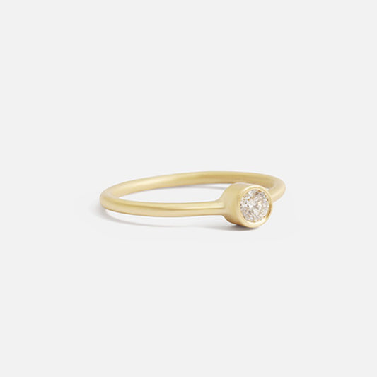 Indulge in the timeless elegance of our Single Diamond Ring. This sparkling centerpiece features exquisite craftsmanship that will captivate your heart and dazzle on your finger. Elevate your style and make a statement with this stunning piece of jewelry.  3mm Round White Diamond Round Band 14k Yellow Gold Satin Finish WxT: 1.45mm