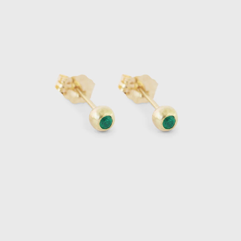Make a statement with these dainty emerald ball studs. With their timeless elegance and vibrant green hue, they are the perfect accessory to add a touch of sophistication to any outfit Two 1.7mm Emeralds 14k Yellow Gold HxW: 3.48mm x 3.52mm